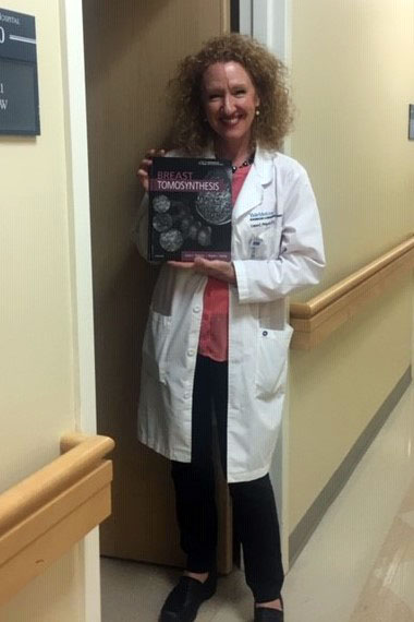 Dr. Liane Philpotts holding the Breast Tomosynthesis textbook
